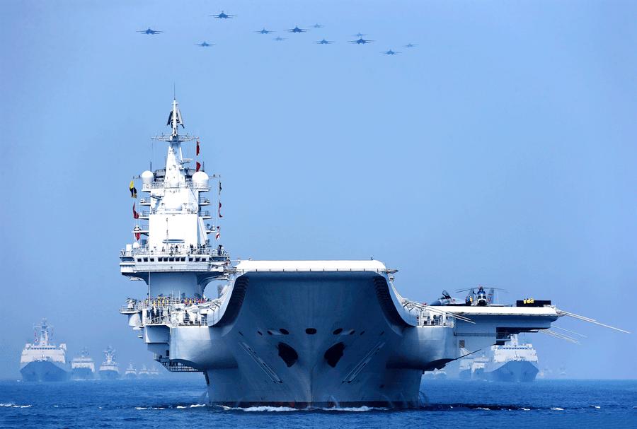 Liaoning, China\'s first aircraft carrier, parades in formation on the South China Sea on April 12, 2018. [ZHANG LEI/FOR CHINA DAILY]