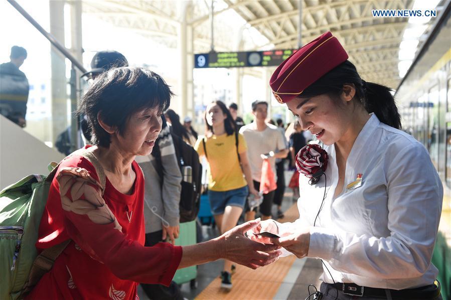 <?php echo strip_tags(addslashes(A passenger (L) consults a staff member before boarding at a railway station in Nanchang, capital of east China's Jiangxi Province, Oct. 1, 2018. The country witnesses a travel rush as people embark on trips for seven-day National Day holiday, which lasts from Oct. 1 to 7. (Xinhua/Bao Gansheng))) ?>