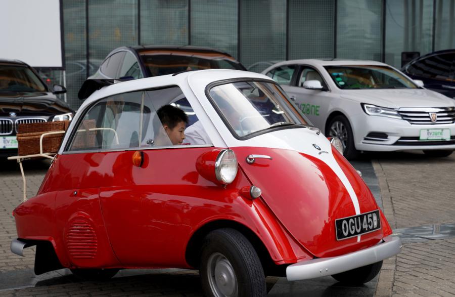 A boy sits in an automobile at Shanghai Auto Museum in Shanghai on Oct. 7, 2018. (Photo/Xinhua)