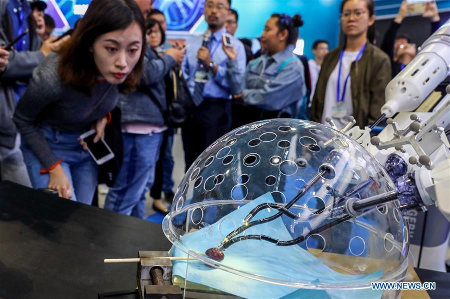 <?php echo strip_tags(addslashes(Members of the press look at a porotic laparoscopic surgery robot system during a press preview of the 2018 National Mass Innovation and Entrepreneurship Week in Beijing, capital of China, Oct. 8, 2018. The weekly event will run from October 9 to 15. (Xinhua/Zhang Yuwei))) ?>