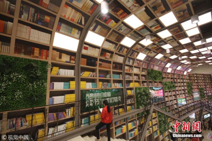 <?php echo strip_tags(addslashes(Tens of thousands of books are placed on shelves to form a 10-meter-tall books wall inside a shopping center in Chongqing, Oct. 10, 2018. (Photo/VCG))) ?>