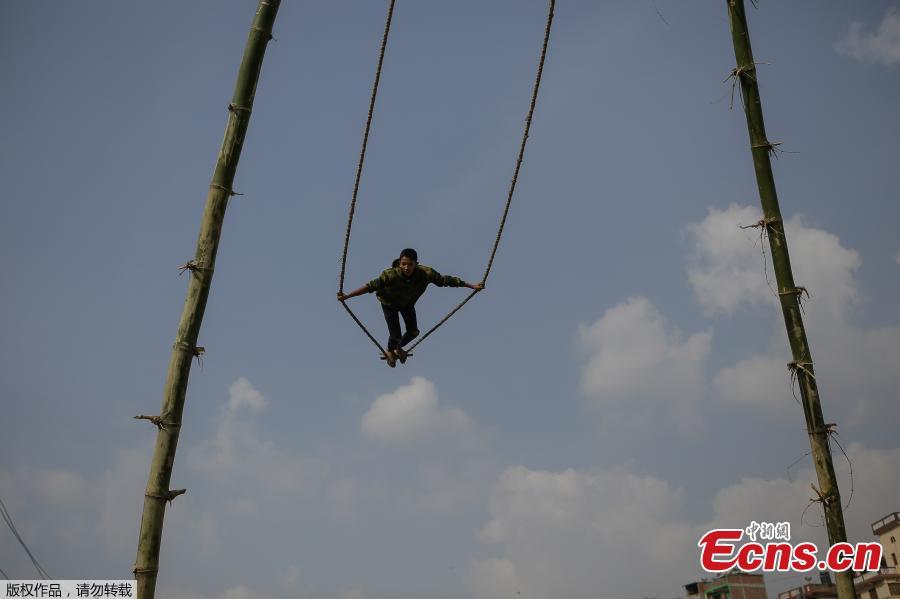 <?php echo strip_tags(addslashes(A child plays on a swing, popularly known as the 'Dashain Ping', ahead of the Hindu festival of Dashain in Kathmandu, Nepal, Oct. 11, 2018. People of all ages often play on a swing in towns and villages during the celiebration of the festival. (Photo: China News Service/Pu Ladan))) ?>