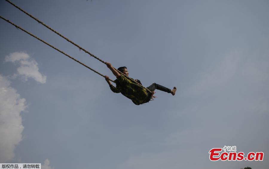 <?php echo strip_tags(addslashes(A child plays on a swing, popularly known as the 'Dashain Ping', ahead of the Hindu festival of Dashain in Kathmandu, Nepal, Oct. 11, 2018. People of all ages often play on a swing in towns and villages during the celiebration of the festival. (Photo: China News Service/Pu Ladan))) ?>