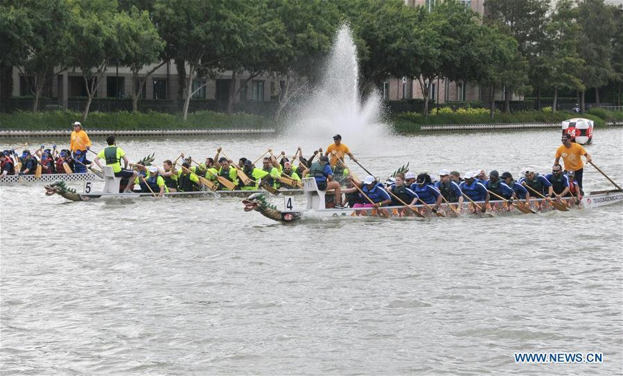 Contestants paddle during a dragon boat race in Houston, Texas, the United States, Oct. 13, 2018. The 15th annual Gulf Coast International Dragon Boat Regatta kicked off on Saturday in Sugar Land in Southwest Houston, Texas, the United States, aiming to promote the tradition and share this aspect of Asian culture. (Xinhua/Sun Jiayi)
