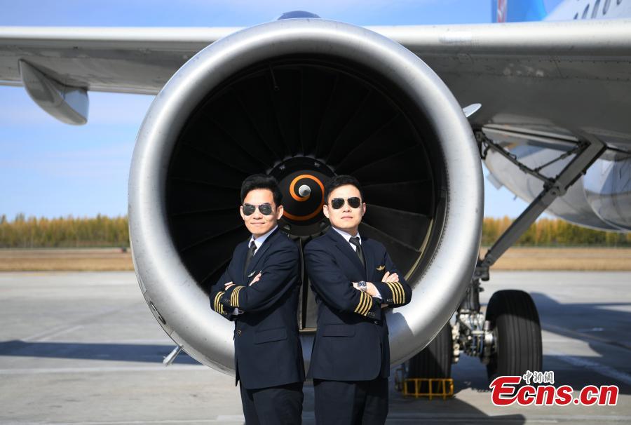 <?php echo strip_tags(addslashes(Twin brothers Liu Ke (L) and Liu Xin pose for a photo near a China Southern Airlines aircraft on Oct. 16, 2018. The twin brothers, born in 1987, were from a young age both interested in becoming pilots. After graduating high school, they both went on to study at the Civil Aviation Flight University of China. Later, both became pilots for China Southern Airlines. (Photo: China News Service/Zhang Yao))) ?>