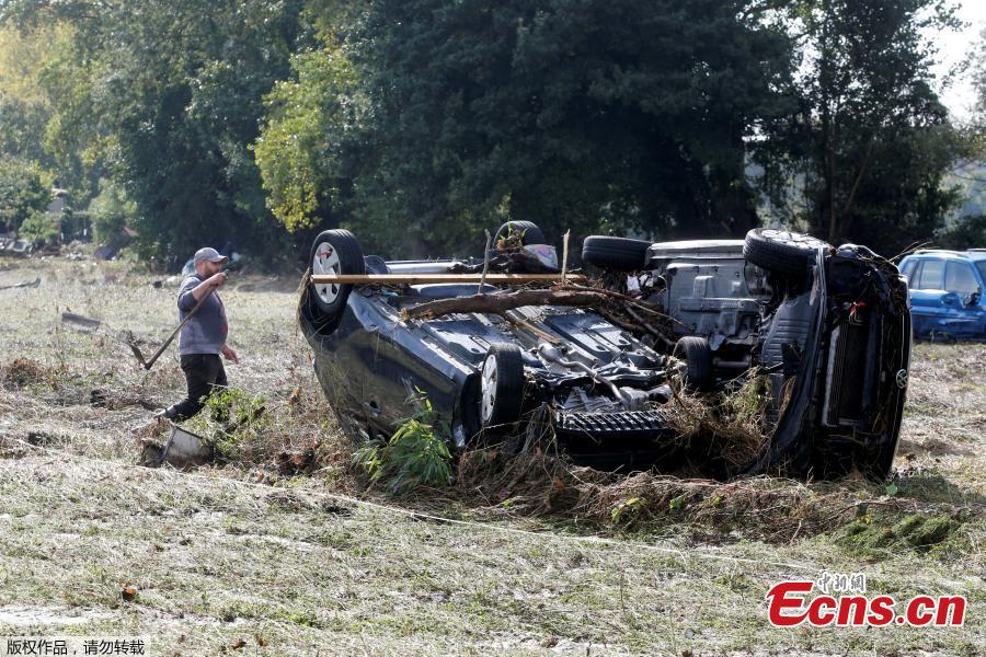A man stands by a damaged car as clean-up operations continue the day after some of the worst flash floods in a century turned rivers into raging torrents that engulfed homes and swept away cars hit the southwestern Aude district of France, in Conques, France, Oct. 16, 2018. At least 12 people died. (Photo/Agencies)