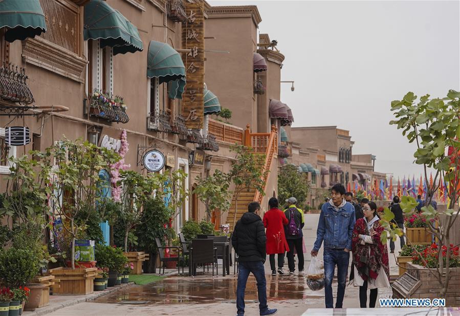 <?php echo strip_tags(addslashes(People walk on a shopping street in Kashgar City, northwest China's Xinjiang Uygur Autonomous Region, Oct. 16, 2018. The ancient oasis city of Kashgar, in the westernmost part of China near the border with Kyrgyzstan, Tajikistan, Afghanistan, and Pakistan, was an important staging post on the original Silk Road and has been revitalized as a bustling hub of business and different cultures. (Xinhua/Hu Huhu))) ?>