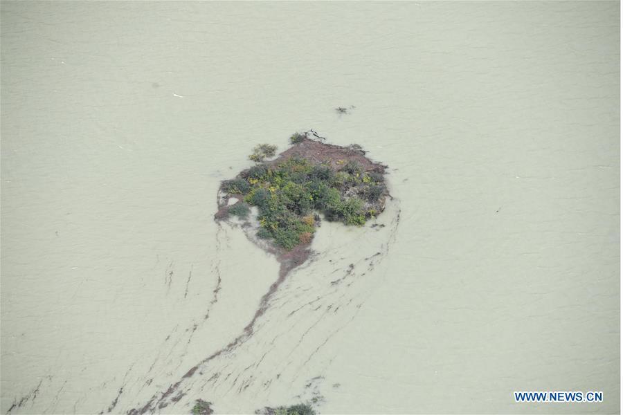 <?php echo strip_tags(addslashes(Aerial photo taken on Oct. 18, 2018 shows the barrier lake on the Yarlung Tsangpo River in Menling County, southwest China's Tibet Autonomous Region. More than 6,000 people have been evacuated after a barrier lake formed following a landslide in the Yarlung Tsangpo River in southwest China's Tibet Autonomous Region, local authorities said Thursday. According to the local disaster relief headquarters, the landslide struck during the early hours of Wednesday near a village in Menling County, blocking the river's waterway. The amounts of water in the lake has surpassed 300 million cubic meters. No casualties have been reported. Authorities in Tibet have launched an emergency response, monitoring the lake's water level, evacuating local residents and sending relief supplies to the disaster-hit areas. (Xinhua/Purbu Zhaxi))) ?>