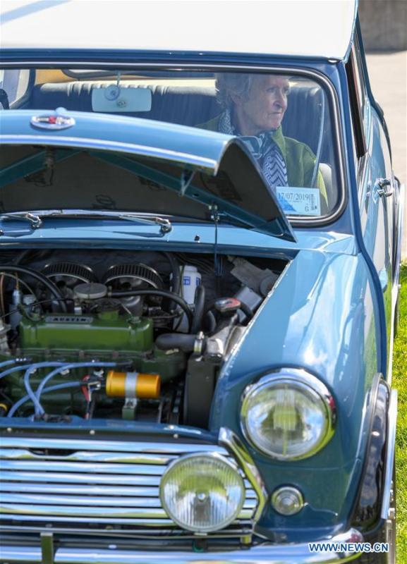 The owner of a BMW MINI Cooper vehicle sits in her car in Wellington, New Zealand, on Oct. 20, 2018. More than 120 BMW MINI Cooper vehicles are displayed during the 24th Mini Nationals Show and Shine. (Xinhua/Guo Lei)