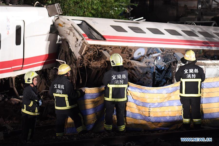 <?php echo strip_tags(addslashes(Photo taken on Oct. 21, 2018 shows the rescuing site of the train derailment accident in Yilan County, southeast China's Taiwan. At least 18 people died and another 120 injured, after a passenger train derailed in Taiwan on Sunday afternoon, according to the island's railway authority. The Puyuma Express No. 6432 bound for Taitung from Shulin Station with 366 passengers on board derailed at 4:50 p.m. local time at Su'aoxin Station in Yilan County. A total of 17 people were declared dead before being sent to hospital. Five of the eight cars of the express train overturned. The cause of the derailment is still under investigation. (Xinhua/Jin Liangkuai))) ?>