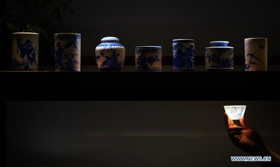 <?php echo strip_tags(addslashes(A luminous eggshell porcelain teacup is seen in a hand of a visitor in Jingdezhen, east China's Jiangxi Province, on Oct. 19, 2018. Eggshell porcelain, one of the traditional porcelains produced in 