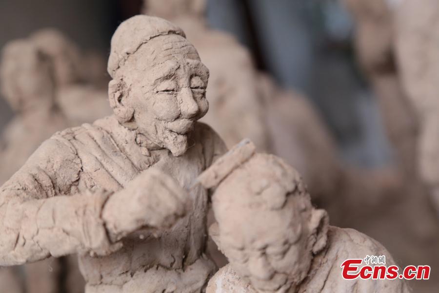Clay sculpture enthusiast Zhao Tiejun shows his creations featuring past rural life and farming traditions in his home in Pingliang City, Northwest China’s Gansu Province, Oct. 23, 2018. Zhao has been fascinated with the hobby of making clay figurines for two decades as he believes the handicraft can help younger generation learn about the countryside life now increasingly transformed. (Photo: China News Service/Zheng Bing)