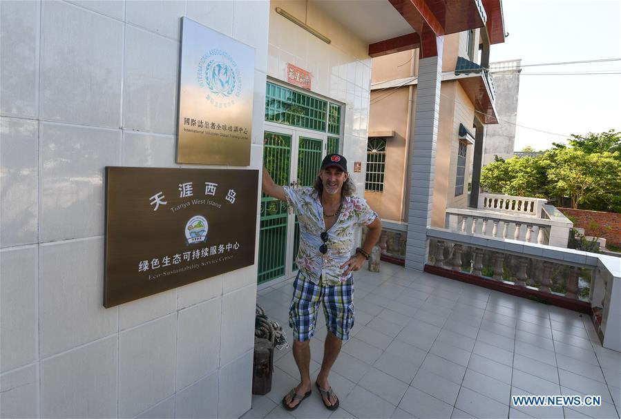 Canadian Craig Anderson poses for a photo at the eco-sustainability service center of the West Island in Sanya, south China\'s Hainan Province, Sept. 19, 2018. Anderson arrived in February at the West Island inhabited by around 4,000 people. Locals regarded Anderson as a scavenger when he first arrived, as he wandered around the beach almost every day, picking up driftwood, plastic bottles, shattered glasses, and rusty pieces of iron. As time went by, the locals realized that Anderson is an artist who devotes himself in environment protection art design. He profits the recyclable and regenerative materials in making art works. (Xinhua/Yang Guanyu)