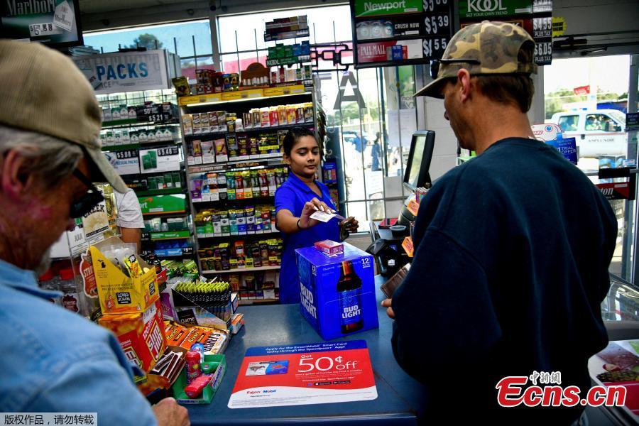 <?php echo strip_tags(addslashes(Twinkle Patel interacts with a regular customer at the KC Mart in Simpsonville, South Carolina, U.S., Oct. 24, 2018.(Photo/Agencies))) ?>