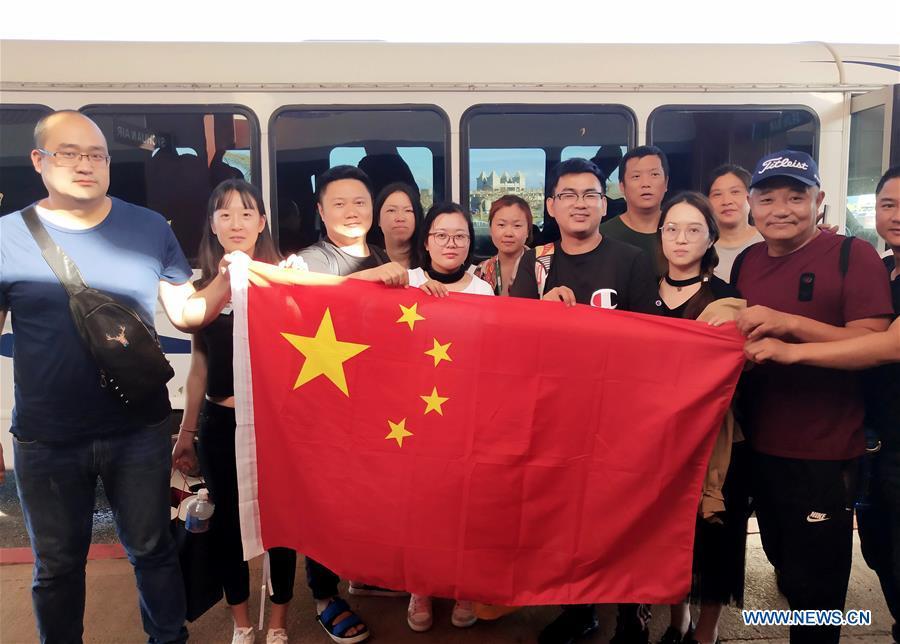 <?php echo strip_tags(addslashes(Chinese tourists pose with Chinese national flag before starting to fly back home in Saipan, the Commonwealth of the Northern Mariana Islands (CNMI), Oct. 28, 2018. Some 1,500 Chinese tourists trapped in Saipan by Super Typhoon Yutu started to fly back home on Sunday. (Xinhua))) ?>