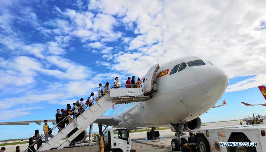 Chinese tourists get on board to fly back home in Saipan, the Commonwealth of the Northern Mariana Islands (CNMI), Oct. 28, 2018. Some 1,500 Chinese tourists trapped in Saipan by Super Typhoon Yutu started to fly back home on Sunday. (Xinhua)