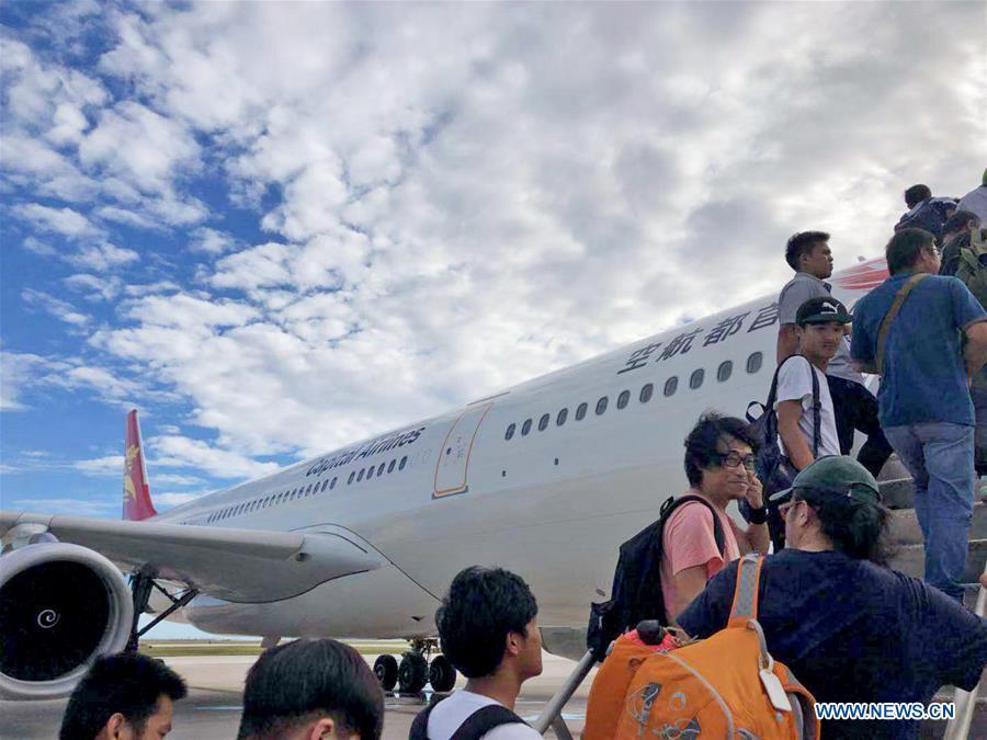Chinese tourists get on board to fly back home in Saipan, the Commonwealth of the Northern Mariana Islands (CNMI), Oct. 28, 2018. Some 1,500 Chinese tourists trapped in Saipan by Super Typhoon Yutu started to fly back home on Sunday. (Xinhua)