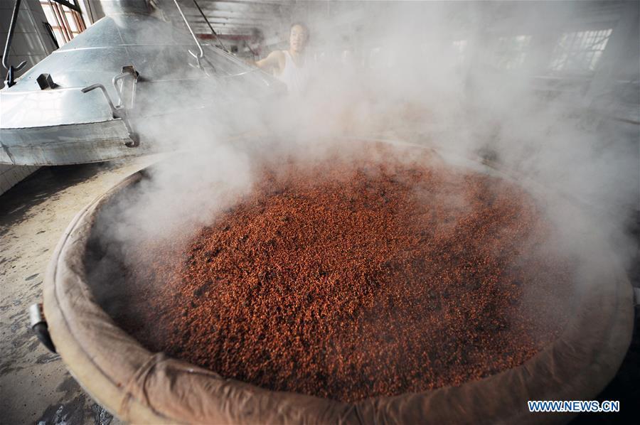 Workers process sorghum grains at a distillery in Maotai town in the city of Renhuai in southwest China\'s Guizhou Province, Oct. 23, 2018. Maotai is a small town in Renhuai City in mountainous Guizhou. What distinguishes it from other Chinese small towns is that it produces a famous brand of Chinese liquor Moutai, which often served on official occasions and at state banquets. The spirit, made from sorghum and wheat, takes up to five years for the whole production process, involving nine times of steaming, eight times of fermentation and seven times of distillation, before aged in clay pots. Moutai is also considered a luxury item that has long been a popular gift. China\'s alcohol industry earned about 1 trillion yuan in revenue in 2017. The total profits rose by 36 percent year on year to over 100 billion yuan, according to China National Light Industry Council. (Xinhua/Yang Wenbin)