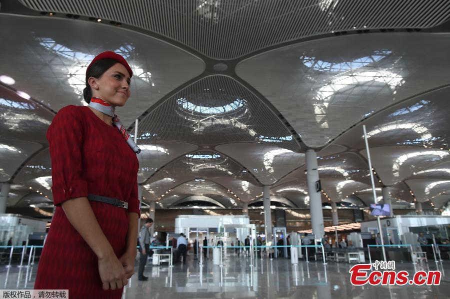 A Turkish Airlines stewardess poses at a terminal of the Istanbul\'s new airport prior to the official opening ceremony, in Istanbul, Turkey, Oct. 29, 2018. (Photo/Agencies)