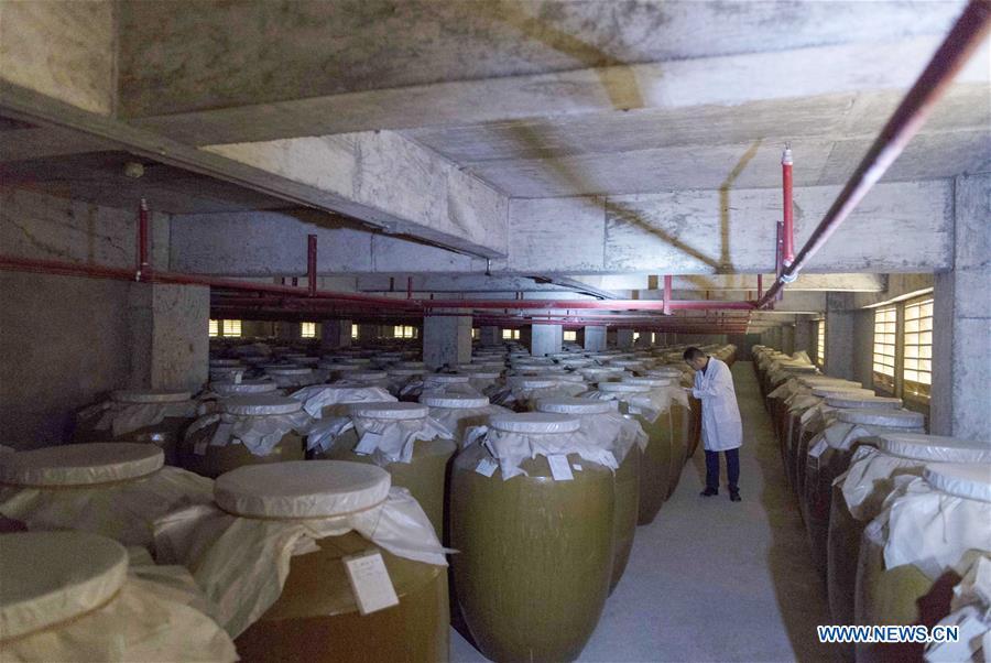 A worker checks liquor at a distillery in Maotai town in the city of Renhuai in southwest China\'s Guizhou Province, Oct. 28, 2018. Maotai is a small town in Renhuai City in mountainous Guizhou. What distinguishes it from other Chinese small towns is that it produces a famous brand of Chinese liquor Moutai, which often served on official occasions and at state banquets. The spirit, made from sorghum and wheat, takes up to five years for the whole production process, involving nine times of steaming, eight times of fermentation and seven times of distillation, before aged in clay pots. Moutai is also considered a luxury item that has long been a popular gift. China\'s alcohol industry earned about 1 trillion yuan in revenue in 2017. The total profits rose by 36 percent year on year to over 100 billion yuan, according to China National Light Industry Council. (Xinhua/Chen Yong)