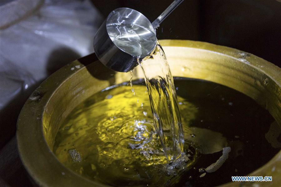 A worker checks liquor at a distillery in Maotai town in the city of Renhuai in southwest China\'s Guizhou Province, Oct. 28, 2018. Maotai is a small town in Renhuai City in mountainous Guizhou. What distinguishes it from other Chinese small towns is that it produces a famous brand of Chinese liquor Moutai, which often served on official occasions and at state banquets. The spirit, made from sorghum and wheat, takes up to five years for the whole production process, involving nine times of steaming, eight times of fermentation and seven times of distillation, before aged in clay pots. Moutai is also considered a luxury item that has long been a popular gift. China\'s alcohol industry earned about 1 trillion yuan in revenue in 2017. The total profits rose by 36 percent year on year to over 100 billion yuan, according to China National Light Industry Council. (Xinhua/Chen Yong)