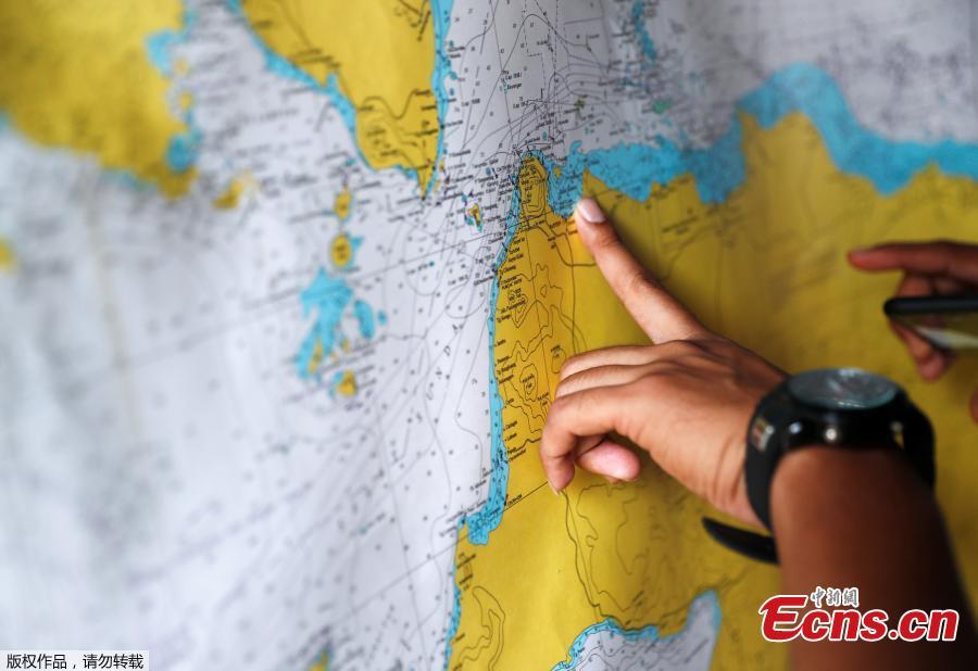 An Indonesian police officer studies a map in the search and rescue command center for the Lion Air flight JT610 crash, at Tanjung Priok port in Jakarta, Indonesia, Oct. 30, 2018. Indonesia on Tuesday stepped up a search for an airliner that plunged into the sea with all 189 aboard feared dead, deploying underwater beacons to trace its black box recorders and uncover why an almost-new plane crashed minutes after take-off. (Photo/Agencies)