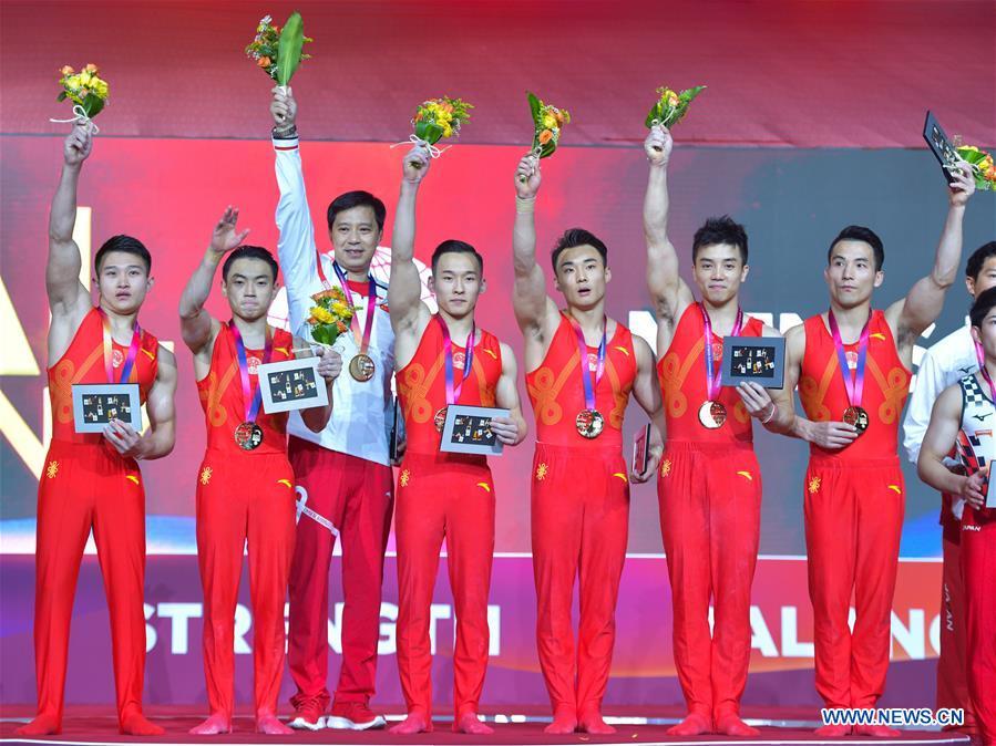 Members of team China celebrate on the podium after winning the Men\'s Team Final at the 2018 FIG Artistic Gymnastics Championships in Doha, capital of Qatar, Oct. 29, 2018. Team China won the gold medal. (Xinhua/Nikku)