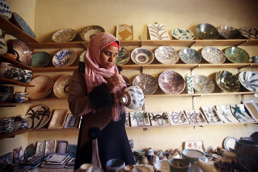 An artist works during the eighth annual Tunis Pottery and Handcrafts Festival in Tunis village, Fayoum province, south of Cairo, capital of Egypt, on Nov. 1, 2018. Crowds of local and foreign visitors have been walking around the little pottery and art shops of Tunis village during the eighth annual Tunis Pottery and Handcrafts Festival. The three-day festival, which kicked off on Nov. 1, showcases unique artworks of pottery and several other handcrafts including wood and granite carving, basket making, handmade carpets, needlework, clay objects and hammered copper. (Xinhua/Ahmed Gomaa)
