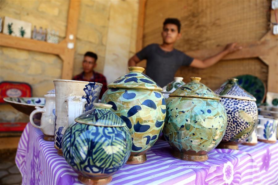 Artworks are seen during the eighth annual Tunis Pottery and Handcrafts Festival in Tunis village, Fayoum province, south of Cairo, capital of Egypt, on Nov. 1, 2018. Crowds of local and foreign visitors have been walking around the little pottery and art shops of Tunis village during the eighth annual Tunis Pottery and Handcrafts Festival. The three-day festival, which kicked off on Nov. 1, showcases unique artworks of pottery and several other handcrafts including wood and granite carving, basket making, handmade carpets, needlework, clay objects and hammered copper. (Xinhua/Ahmed Gomaa)