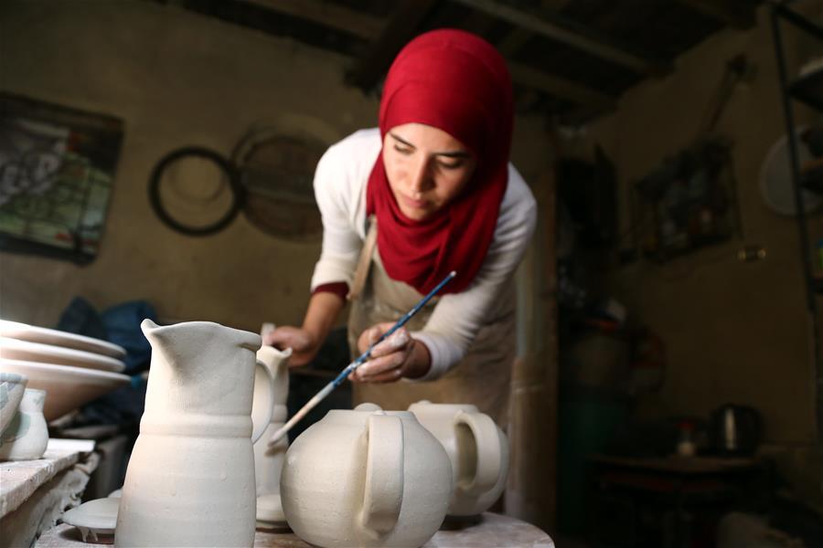 An artist works during the eighth annual Tunis Pottery and Handcrafts Festival in Tunis village, Fayoum province, south of Cairo, capital of Egypt, on Nov. 1, 2018. Crowds of local and foreign visitors have been walking around the little pottery and art shops of Tunis village during the eighth annual Tunis Pottery and Handcrafts Festival. The three-day festival, which kicked off on Nov. 1, showcases unique artworks of pottery and several other handcrafts including wood and granite carving, basket making, handmade carpets, needlework, clay objects and hammered copper. (Xinhua/Ahmed Gomaa)