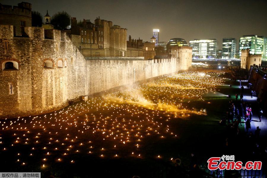 <?php echo strip_tags(addslashes(The moat of the Tower of London are seen filled with thousands of lit torches as part of the installation 