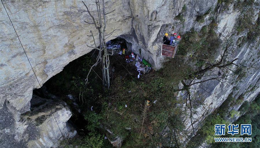 <?php echo strip_tags(addslashes(Water exploration team members reach the Tianbao cave in Tianfengping village by being lowered to it in an iron basket, Oct. 31, 2018.  (Photo/Xinhua))) ?>