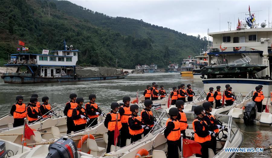 Chinese police officers take part in the launching ceremony of the joint patrol of police force from China, Laos, Myanmar and Thailand along the Mekong River in Guanlei Port in Dai Autonomous Prefecture of Xishuangbanna, southwest China\'s Yunnan Province, Dec. 10, 2011. The 76th Mekong River joint patrol led by China, Laos, Myanmar, and Thailand started Nov. 20, 2018 from Guanlei Port, Xishuangbanna Dai Autonomous Prefecture in southwest China\'s Yunnan Province. According to Yunnan border police bureau, the joint patrol will last five days and cover a range of over 500 kilometers to enhance anti-terrorism capability, safeguard the security and crack down on cross-border crimes. Once every month since 2011, the patrols targeting drug trafficking, smuggling and other cross-border crimes along the Mekong, conduct random inspections in waters near key regions, including the Golden Triangle.The Mekong River, known as the Lancang River at the Chinese stretch, runs through China, Laos, Myanmar, Thailand, Cambodia and Vietnam. It is an important waterway for transnational shipping and a border area known for criminal activities. For seven years, security cooperation between the four countries has been getting closer with joint patrols a regular monthly phenomenon. The patrol includes anti-terrorism drills, police skill practices and anti-drug campaigns. Since December 2011, the joint patrols have covered more than 39,500 kilometers, with 122 merchant ships rescued and 582.28 kilograms of drugs seized. The cooperation has expanded to the cracking down on terrorism and human trafficking, as well as joint search and rescue. (Xinhua/Wang Xiaoxue)