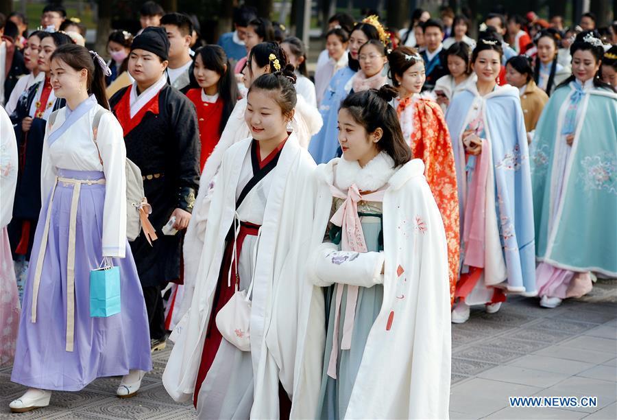 People wearing Hanfu, Chinese traditional costume, walk during an event at the Daming Palace National Heritage Park in Xi\'an, capital of northwest China\'s Shaanxi Province, Nov. 24, 2018. More than 400 Hanfu lovers attended the event to promote traditional Chinese culture. (Xinhua/Liu Xiao)