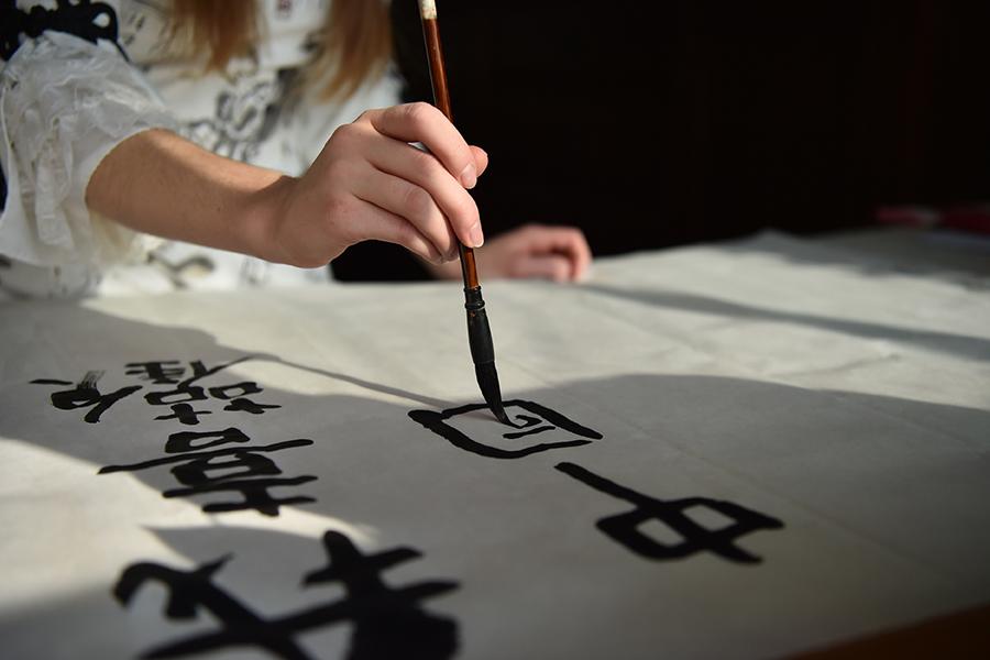 Francis practices calligraphy at home. (Photo/Xinhua)