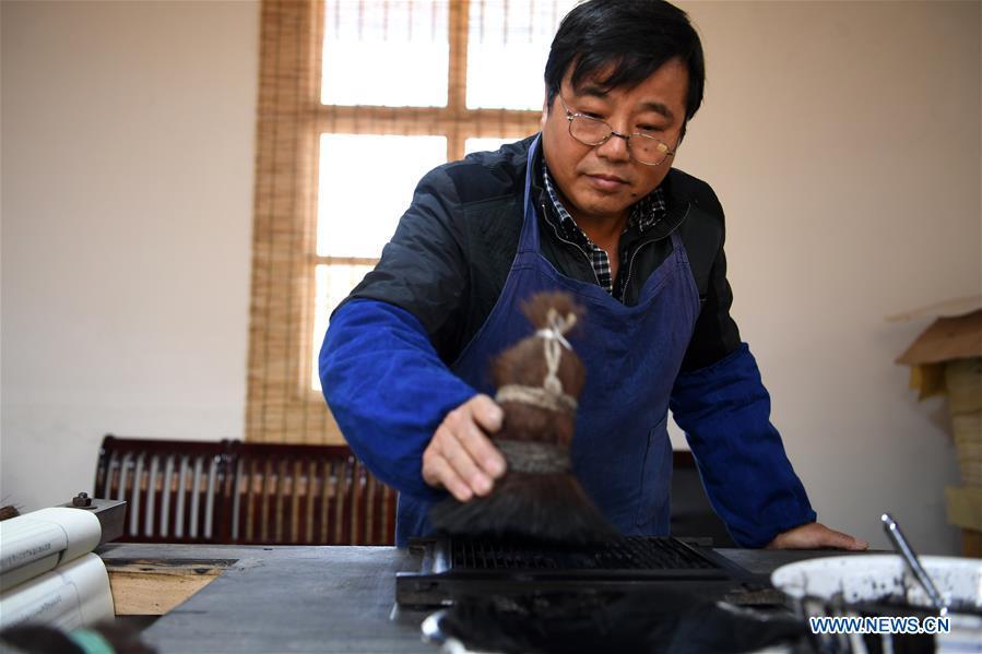 <?php echo strip_tags(addslashes(Lei Shitai works in Chanshan Village of Qinxi Town, Jingxian County, in east China's Anhui Province, Nov. 23, 2018. Lei, 52, born in neighboring Jiangxi Province, started his career as a typography printer when he finished his apprenticeship with his uncle who he followed since he was 17. The traditional printing method witnessed an increasingly hard time in the recent years as a livelihood. It was in 2017 when he decided to move to Chanshan at the invitation of Kai Yuanhong, a local cabinet maker, to cooperate in a broader way. Lei is now working with the traditional technique in a larger scale. (Xinhua/Zhang Duan))) ?>