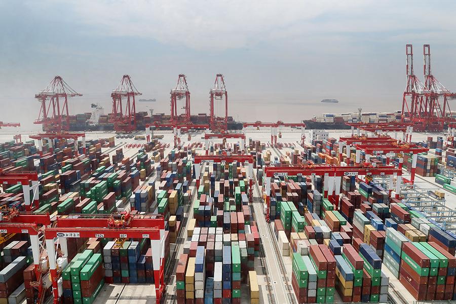 Cargo containers pack the Yangshan port in the Shanghai Pilot Free Trade Zone on May 17. (Photo/Xinhua)
New mission

About 40 years ago, China established special economic zones, which served as windows and testing grounds when the authorities decided to open the domestic market and modernize the country\'s economy.

Foreign investment flowed in, new regulations were issued and new technologies were tested first in these areas－later spreading to other parts of the country, contributing to the fast growth of China\'s economy over the years.

Observers see the establishment of pilot FTZs as a new move for China to push ahead reform and opening-up in a new domestic and external environment.

Compared with special economic zones, pilot FTZs aim to achieve mutual benefit and enable the country to participate in global economic cooperation and competition at a higher level, Luo Qinghe, a professor with Shenzhen University, wrote in a research paper.

A raft of measures have been taken for pilot FTZs to create a more investor-friendly business environment in support of fair competition.

The negative list for foreign investment, for instance, has been shortened in pilot FTZs to broaden market access. Over the past five years, the negative list has been shortened from 190 to 45 items in the Shanghai Pilot FTZ.

The Liaoning Pilot FTZ, the only pilot FTZ in Northeast China, upgraded the processes for examination and approval in the port of Dalian to facilitate the circulation of goods, with the cost for customs clearance slashed by 10 percent.

\