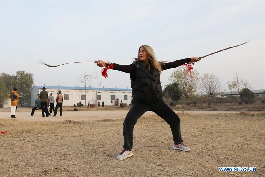 Ana Fidalgo practices Taiji swords in Chenjiagou Village of Wenxian County, central China\'s Henan Province, Nov. 25, 2018. Ana, who comes from Sao Paulo, Brazil, loves Chinese culture, and is a fan of Taiji. It\'s the third time that she comes to Chenjiagou Village to study Taiji. She has taught what she has learned in China in her hometown when coming back to Brazil in recent years, hoping to benefit more people. (Xinhua/Xu Hongxing)