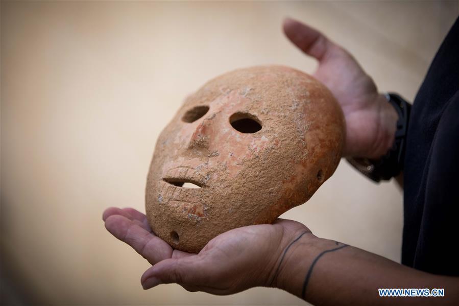 <?php echo strip_tags(addslashes(Ronit Lupu, an archeologist from the Israel Antiquities Authority (IAA), holds a stone mask at the Rockefeller Museum in Jerusalem, on Nov. 28, 2018. A rare pre-historic stone mask, dating back to the Pre-Pottery Neolithic B (PPNB) period 9,000 years ago, was discovered in the southern West Bank, the Israel Antiquities Authority said Wednesday. (Xinhua/JINI))) ?>