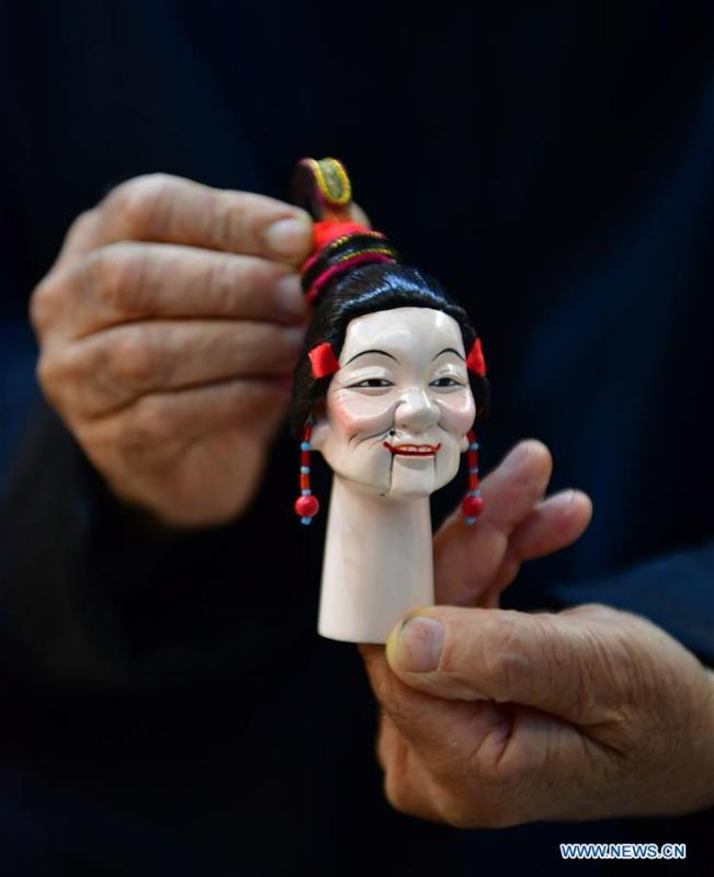 <?php echo strip_tags(addslashes(Xu Zhuchu, a national-level intangible cultural heritage inheritor of Zhangzhou wood puppet head carving, displays a wood puppet head at a studio in Zhangzhou City, southeast China's Fujian Province, Nov. 28, 2018. Listed as one of the national intangible cultural heritages in 2006, Zhangzhou wood puppet carving features exquisite craftsmanship. Xu's works of puppet head carving are known for rich and delicate facial expressions. Nowadays, Xu and his son, Xu Qiang, set up a studio of wood puppet to popularize local puppet culture. (Xinhua/Wei Peiquan))) ?>