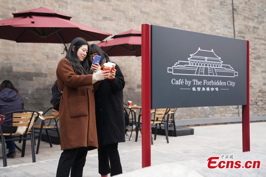 <?php echo strip_tags(addslashes(Girls take selfies outside a café newly opened outside the Palace Museum's Shenwu Men, or the Gate of Divine Might in Beijing on December 1, 2018. Named “Café by The Forbidden City”, the coffee shop in the theme of imperial China enables their customers to enjoy a wide range of drinks while experiencing ancient Chinese culture.  (Photo: China News Service/ Du Yang))) ?>