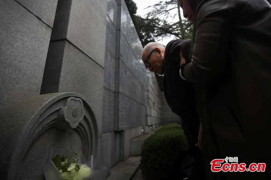Survivor of the Nanjing Massacre Yu Changxiang (L), 91, pays tribute to the victims of the Nanjing Massacre before the memorial hall wall where the victims\' names are engraved during commemoration activities in Nanjing, capital of east China\'s Jiangsu Province, Dec. 3, 2018. The Nanjing Massacre took place when Japanese troops captured the city on Dec. 13, 1937. Over six weeks, they killed 300,000 Chinese civilians and unarmed soldiers. In February 2014, China\'s top legislature designated December 13 as the national memorial day for victims of the Nanjing Massacre. Starting Monday, family members of the victims began a series of commemoration activities such as laying flowers, burning incense and reading letters in front of the Memorial Hall of the Victims in Nanjing Massacre by Japanese Invaders.(Photo: China News Service/Yang Bo)