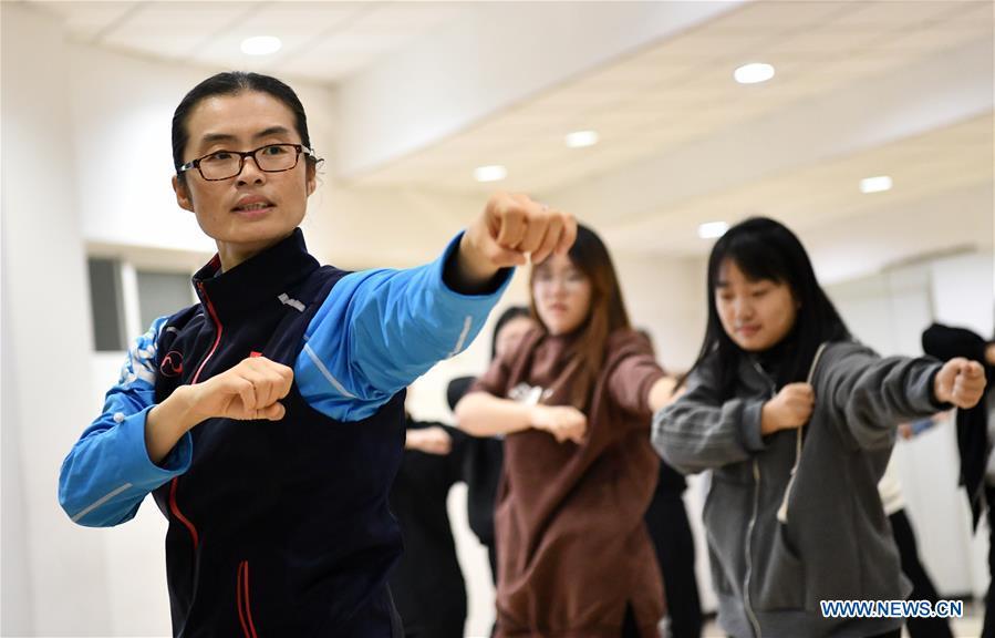 Huo Jinghong, the 5th generation descendant of Huo Yuanjia, a Chinese martial arts master, teaches martial arts at Tianjin University of Commerce in Tianjin, north China, Nov. 26, 2018. As the descendant of Huo Yuanjia, one of China\'s most revered martial arts masters, Huo Jinghong, 41, started practicing martial arts at the age of 5. After her graduation from the Wushu School of Beijing Sport University in major of Wushu Routine, Huo started her career as a gym teacher of Tianjin University of Commerce in the year of 2000. As a gym teacher, Huo teaches martial arts for the university team and offers classes on health Qigong, a new form selected from different versions of traditional Qigong for modern fitness, in the university. Later in 2015, Huo became the inheritor of Huo-style boxing, which was listed as an intangible cultural heritage in Tianjin, and since then, she has devoted herself to the inheritance and development of the martial arts handed down from the older generation of Huo\'s family. She hoped that the Huo-style boxing would help people understand more about the Chinese martial arts. Huo Yuanjia was born in Tianjin in 1868. He founded the Chin Woo Athletic Association in 1910 in Shanghai and advocated the spirit of \