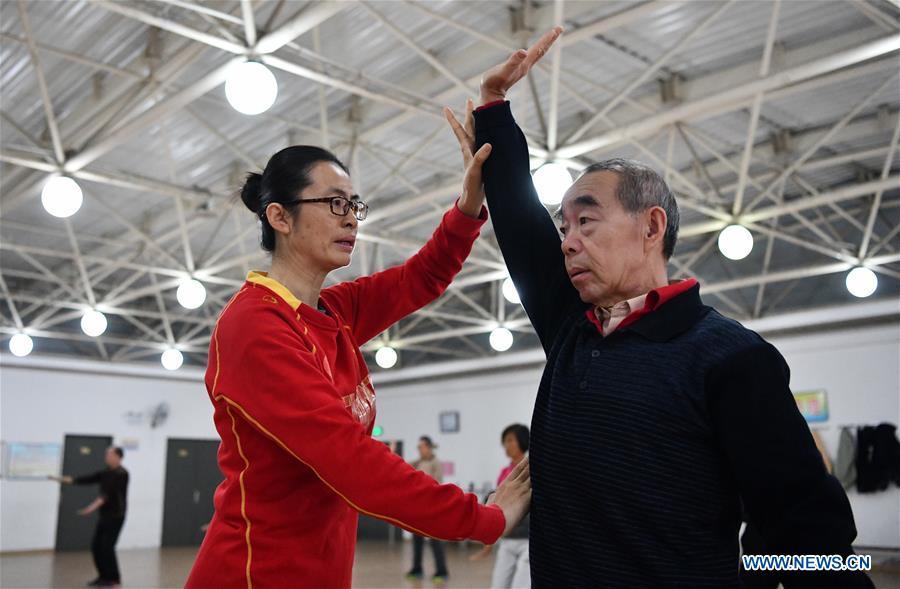 Huo Jinghong, the 5th generation descendant of Huo Yuanjia, a Chinese martial arts master, teaches martial arts at Tianjin University of Commerce in Tianjin, north China, Nov. 28, 2018. As the descendant of Huo Yuanjia, one of China\'s most revered martial arts masters, Huo Jinghong, 41, started practicing martial arts at the age of 5. After her graduation from the Wushu School of Beijing Sport University in major of Wushu Routine, Huo started her career as a gym teacher of Tianjin University of Commerce in the year of 2000. As a gym teacher, Huo teaches martial arts for the university team and offers classes on health Qigong, a new form selected from different versions of traditional Qigong for modern fitness, in the university. Later in 2015, Huo became the inheritor of Huo-style boxing, which was listed as an intangible cultural heritage in Tianjin, and since then, she has devoted herself to the inheritance and development of the martial arts handed down from the older generation of Huo\'s family. She hoped that the Huo-style boxing would help people understand more about the Chinese martial arts. Huo Yuanjia was born in Tianjin in 1868. He founded the Chin Woo Athletic Association in 1910 in Shanghai and advocated the spirit of \