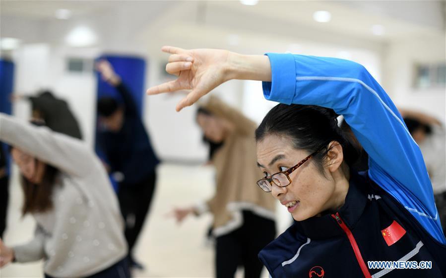 <?php echo strip_tags(addslashes(Huo Jinghong, the 5th generation descendant of Huo Yuanjia, a Chinese martial arts master, demonstrates health Qigong, a traditional martial art combined with meditation, for students at Tianjin University of Commerce in Tianjin, north China, Nov. 26, 2018. As the descendant of Huo Yuanjia, one of China's most revered martial arts masters, Huo Jinghong, 41, started practicing martial arts at the age of 5. After her graduation from the Wushu School of Beijing Sport University in major of Wushu Routine, Huo started her career as a gym teacher of Tianjin University of Commerce in the year of 2000. As a gym teacher, Huo teaches martial arts for the university team and offers classes on health Qigong, a new form selected from different versions of traditional Qigong for modern fitness, in the university. Later in 2015, Huo became the inheritor of Huo-style boxing, which was listed as an intangible cultural heritage in Tianjin, and since then, she has devoted herself to the inheritance and development of the martial arts handed down from the older generation of Huo's family. She hoped that the Huo-style boxing would help people understand more about the Chinese martial arts. Huo Yuanjia was born in Tianjin in 1868. He founded the Chin Woo Athletic Association in 1910 in Shanghai and advocated the spirit of 