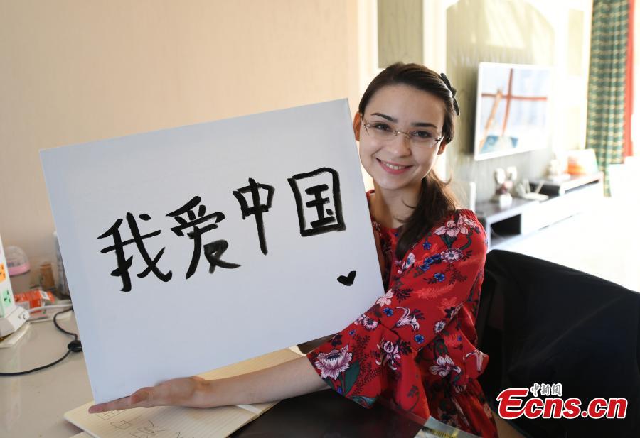 <?php echo strip_tags(addslashes(Valentina shows her calligraphy work at her home in Changchun, Northeast China’s Jilin province. (Photo: China News Service/ Zhang Yao))) ?>