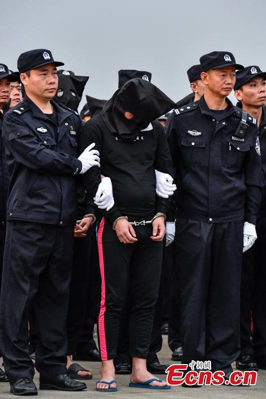 A total of 233 telecom fraudsters were returned from Cambodia to southern China\'s Guangzhou on December 6, 2018. The suspects are behind more than 2,000 fraud cases across over 20 provincial regions, involving over 63 million yuan (about 9.14 million U.S. dollars), according to the police. The police said the suspects changed their phone numbers and pretended to be public security, procuratorate or court officers to threaten the victims for money. (Photo: China News Service/Chen Jimin)