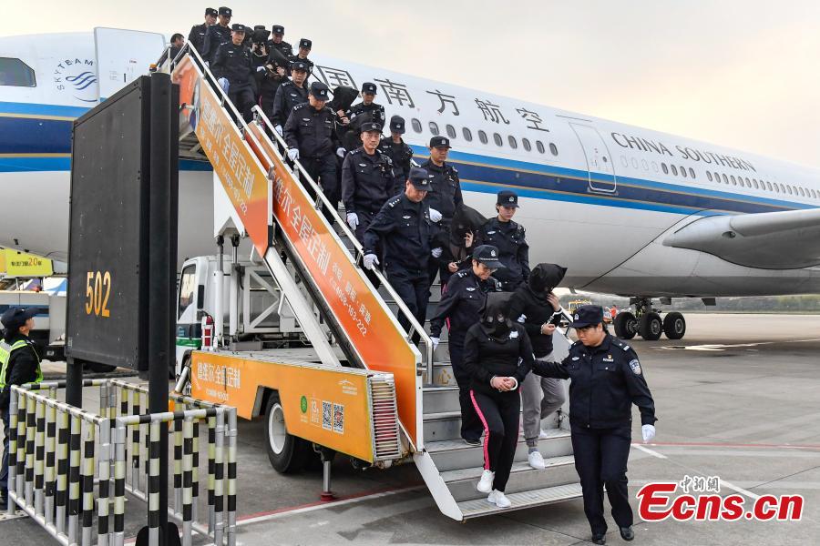 A total of 233 telecom fraudsters were returned from Cambodia to southern China\'s Guangzhou on December 6, 2018. The suspects are behind more than 2,000 fraud cases across over 20 provincial regions, involving over 63 million yuan (about 9.14 million U.S. dollars), according to the police. The police said the suspects changed their phone numbers and pretended to be public security, procuratorate or court officers to threaten the victims for money. (Photo: China News Service/Chen Jimin)