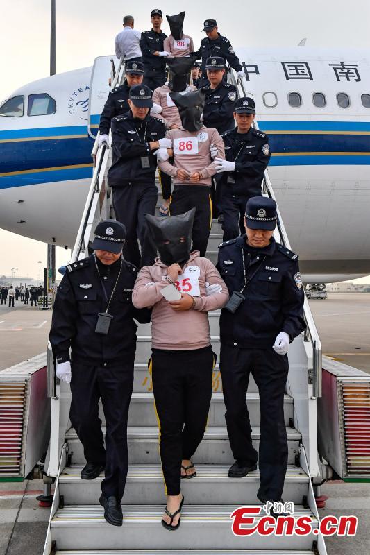 A total of 233 telecom fraudsters were returned from Cambodia to southern China\'s Guangzhou on December 6, 2018. The suspects are behind more than 2,000 fraud cases across over 20 provincial regions, involving over 63 million yuan (about 9.14 million U.S. dollars), according to the police. The police said the suspects changed their phone numbers and pretended to be public security, procuratorate or court officers to threaten the victims for money. (Photo: China News Service/Chen Jimin)