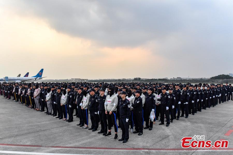 A total of 233 telecom fraudsters were returned from Cambodia to southern China\'s Guangzhou on December 6, 2018. The suspects are behind more than 2,000 fraud cases across over 20 provincial regions, involving over 63 million yuan (about 9.14 million U.S. dollars), according to the police. The police said the suspects changed their phone numbers and pretended to be public security, procuratorate or court officers to threaten the victims for money. (Photo: China News Service/Chen Jimin)
